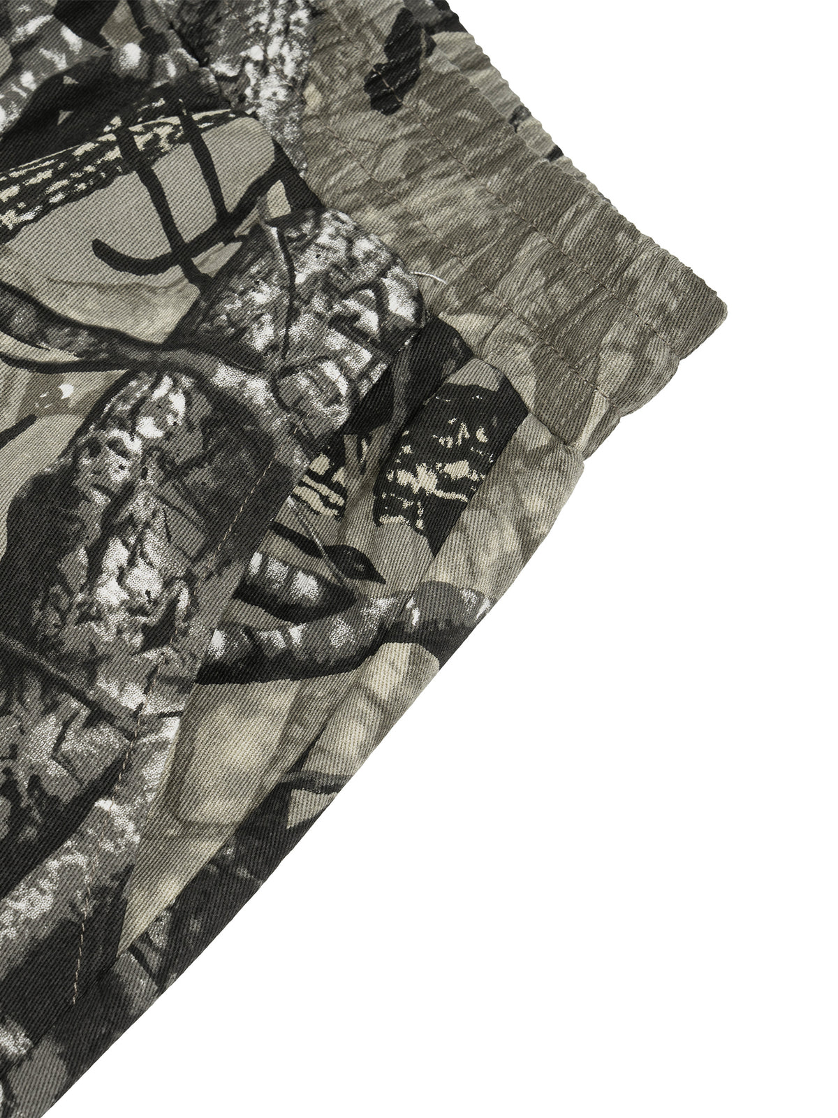 White and grey flame icon on Unisex Tree Camo Barrel Leg Pants
